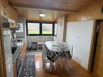 a small kitchen with a table and a sink at Casa Cerralleiro. Casa vacacional en Parada de Sil. Ribeira Sacra. in Parada del Sil
