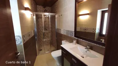 a bathroom with a shower and a sink and a toilet at Casa do Médico in Presqueira
