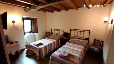 a bedroom with two beds and a window at Casa do Médico in Presqueira
