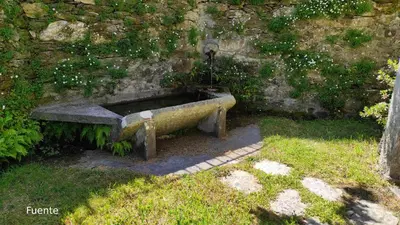 a stone bench sitting against a stone wall at Casa do Médico in Presqueira