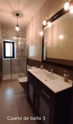 a bathroom with a sink and a toilet and a mirror at Casa do Médico in Presqueira