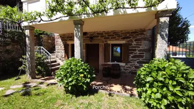 a stone house with a porch and stairs at Casa do Médico in Presqueira