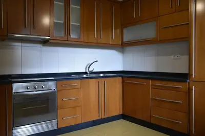 a kitchen with wooden cabinets and a sink at Ribeira Sacra II - Ourense in Nogueira de Ramuin