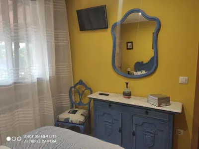 a bedroom with a blue dresser and a mirror at CASA BOREAL in Ourense