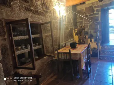 a dining room with a table and a mirror at CASA BOREAL in Ourense