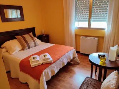 a bedroom with a bed with two towels on it at ACT RIOCOBO in Cervo