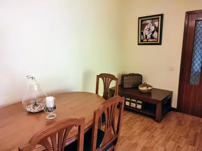 a dining room table with chairs and a lamp on it at ACT RIOCOBO in Cervo