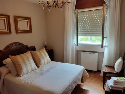 a bedroom with a bed and a window at ACT RIOCOBO in Cervo