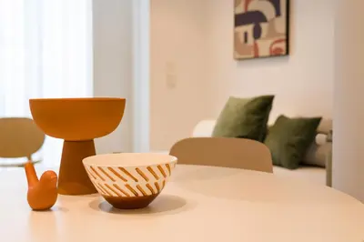 a table with two vases and a bowl on it at SEIS ALDABAS Apartamentos in Santiago de Compostela