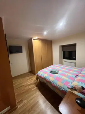 a bedroom with a bed and a wooden floor at Villa Adilia in Padornelo