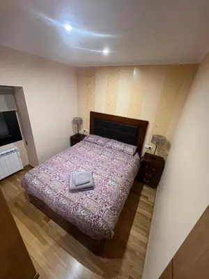 a bedroom with a large bed with a purple comforter at Villa Adilia in Padornelo