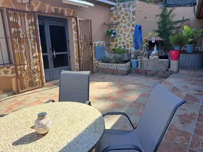 a patio with a table and chairs on a patio at Casa Justa in Castrelo de Miño