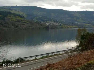 a view of a lake with a road next to it at Casa Justa in Castrelo de Miño