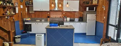 a kitchen with blue and white cabinets and a sink at Casa Justa in Castrelo de Miño