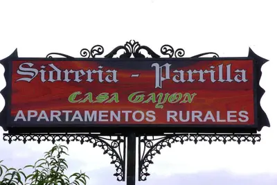 a sign for a restaurant on a pole at Casa Gayón in Pola de Allande