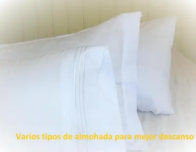 a pile of white pillows on a bed at CASA MARGARITAS in Ourense
