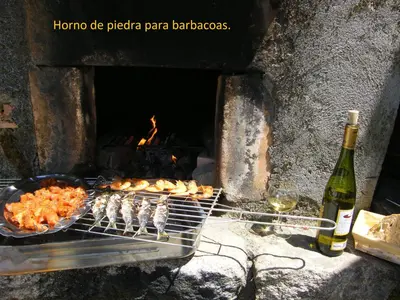 a grill with some food and a bottle of wine at CASA MARGARITAS in Ourense