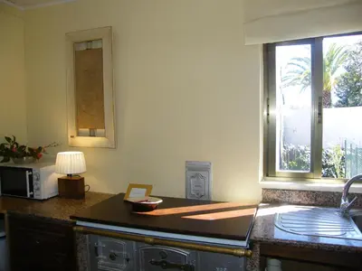 a kitchen with a counter with a microwave and a window at CASA MARGARITAS in Ourense
