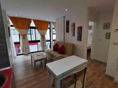 a living room with a couch and a table at Apartamento Carreira Sada in Sada