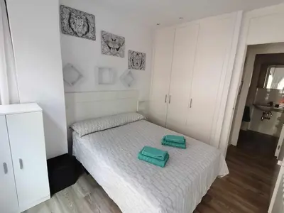 a bedroom with a bed with a green tray on it at Apartamento Carreira Sada in Sada