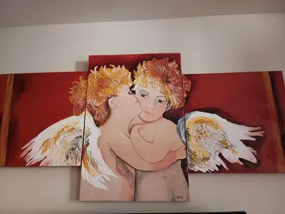 two paintings of angels on a wall at Casa Rural La Torre De Babel in Molinaseca