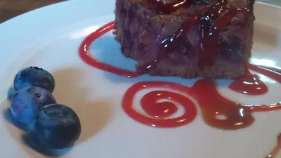 a piece of cake and berries on a white plate at Reitoral de Chandrexa in Parada del Sil