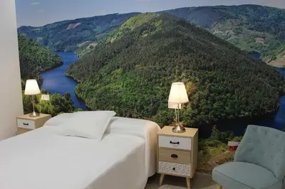 a bedroom with a view of a river and mountains at Acogedor apartamento en el centro de Monforte in Monforte de Lemos
