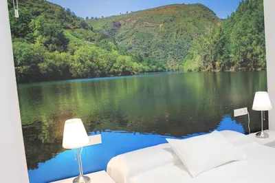 a bedroom with a view of a lake and mountains at Acogedor apartamento en el centro de Monforte in Monforte de Lemos