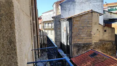 a view of an alley from a balcony at Apartamentos Turísticos y Habitaciones Cidade Vella by Bossh! Hotels in Ourense