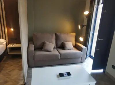 a living room with a couch and a table at Apartamentos Turísticos y Habitaciones Cidade Vella by Bossh! Hotels in Ourense
