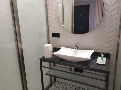 a bathroom with a white sink and a mirror at Apartamentos Turísticos y Habitaciones Cidade Vella by Bossh! Hotels in Ourense