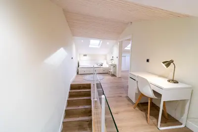 a room with a staircase leading to a bedroom at Apartamentos San Lazaro in Santiago de Compostela