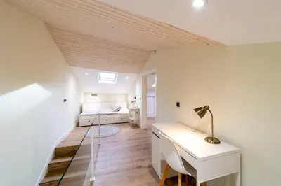 a bedroom with a desk and a bed in a room at Apartamentos San Lazaro in Santiago de Compostela
