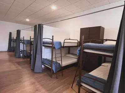 a group of bunk beds in a room at Albergue Melide in Melide