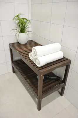 a wooden shelf with towels on it in a bathroom at Albergue Melide in Melide