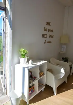 a living room with a white table and a chair at Albergue Melide in Melide