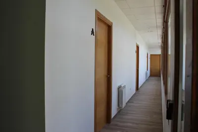 a corridor of an office building with a hallway at Pensión Albergue O Pedregal in Lourenzá