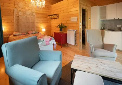 a bedroom with a bed and two chairs and a table at Estudios Galende in Galende