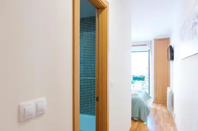 a door leading into a room with a bedroom at Peregrina Pension 3 in O Pedrouzo