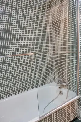 a shower with a white tub in a bathroom at Peregrina Pension 3 in O Pedrouzo