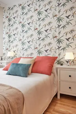 a bedroom with a bed with a tropical wallpaper at Peregrina Pension 3 in O Pedrouzo