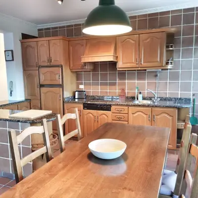 a kitchen with a wooden table with a bowl on it at Casa Courcelles - Viveiro in Viveiro