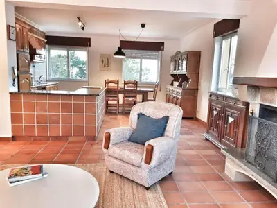 a living room with a chair and a fireplace at Casa Courcelles - Viveiro in Viveiro