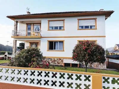 a house with a fence in front of it at Casa Courcelles - Viveiro in Viveiro