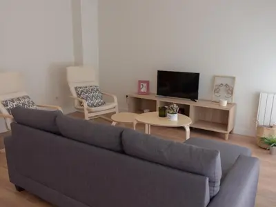 a living room with a couch and a tv at Housingcoruña sada playa in Sada