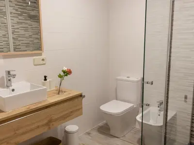 a bathroom with a toilet and a sink and a shower at Housingcoruña sada playa in Sada