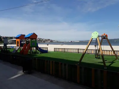 a group of playground equipment next to the beach at Housingcoruña sada playa in Sada