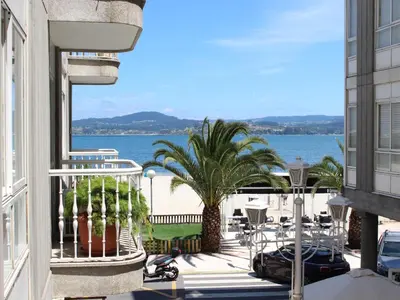 a balcony of a building with a view of the water at Housingcoruña sada playa in Sada