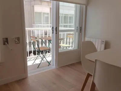 a door to a balcony with a table and chairs at Housingcoruña sada playa in Sada