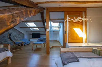 a bedroom with a bed and a living room at Casa Alameda 33 de Casas Das Figueiras en Ría Eo-Ribadeo in Castropol